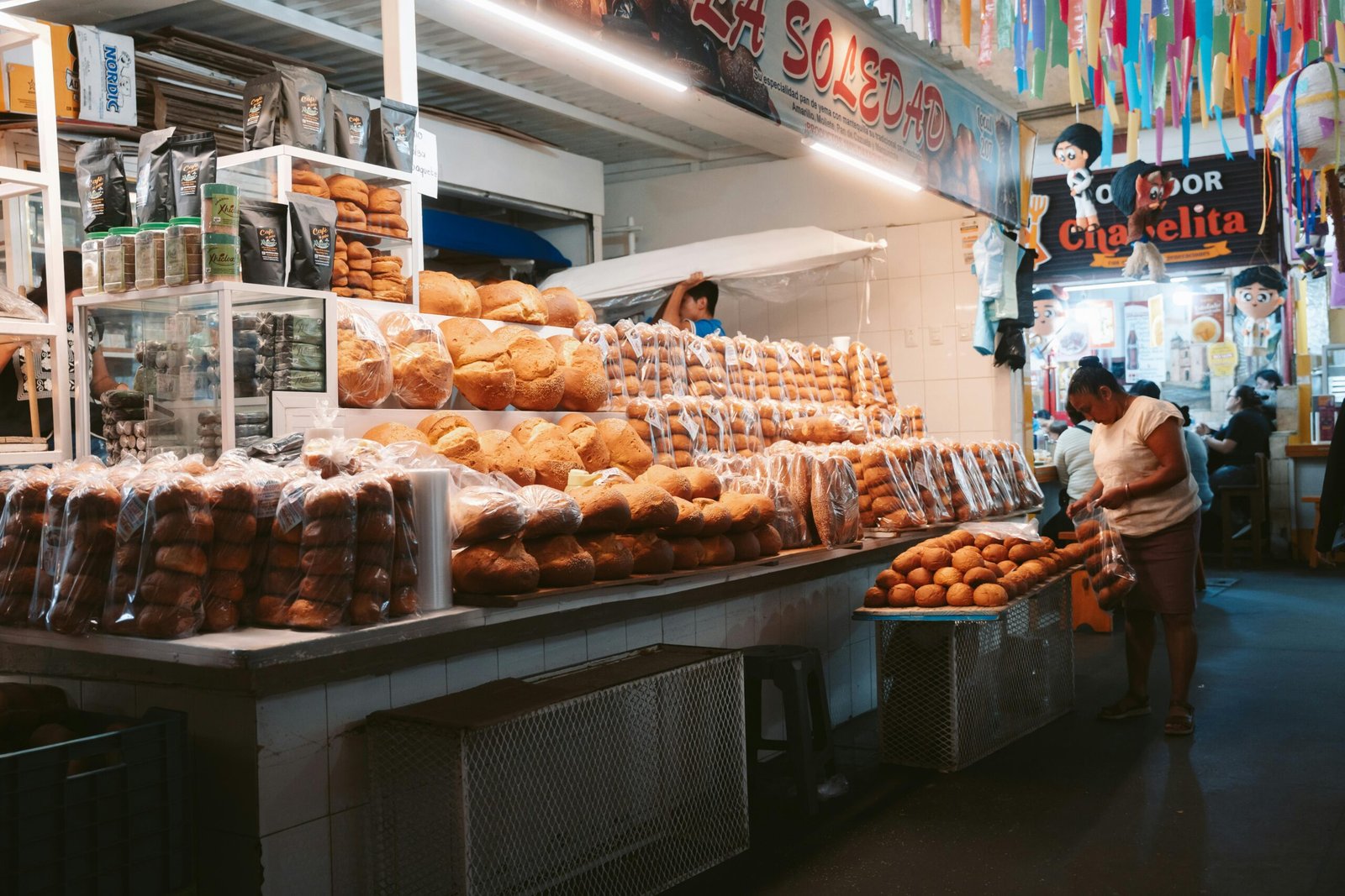 Puesto de pan tradicional en mercado de Oaxaca con pan dulcee mexicano y vendedor local